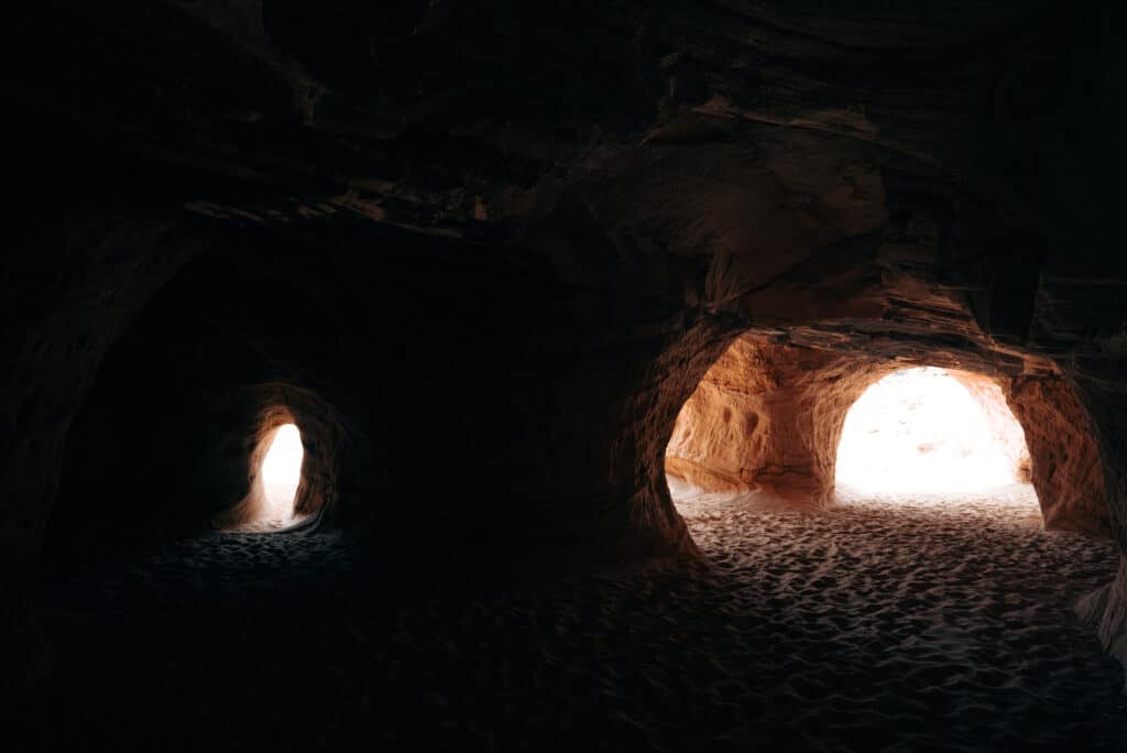 Desert Cave in Utah utah wedding videographer utah corporate videographers beautiful silhouette light coming through red rocks